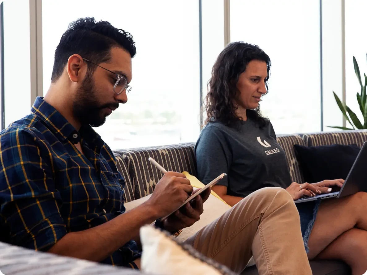 man and woman sitting on a couch in a meeting