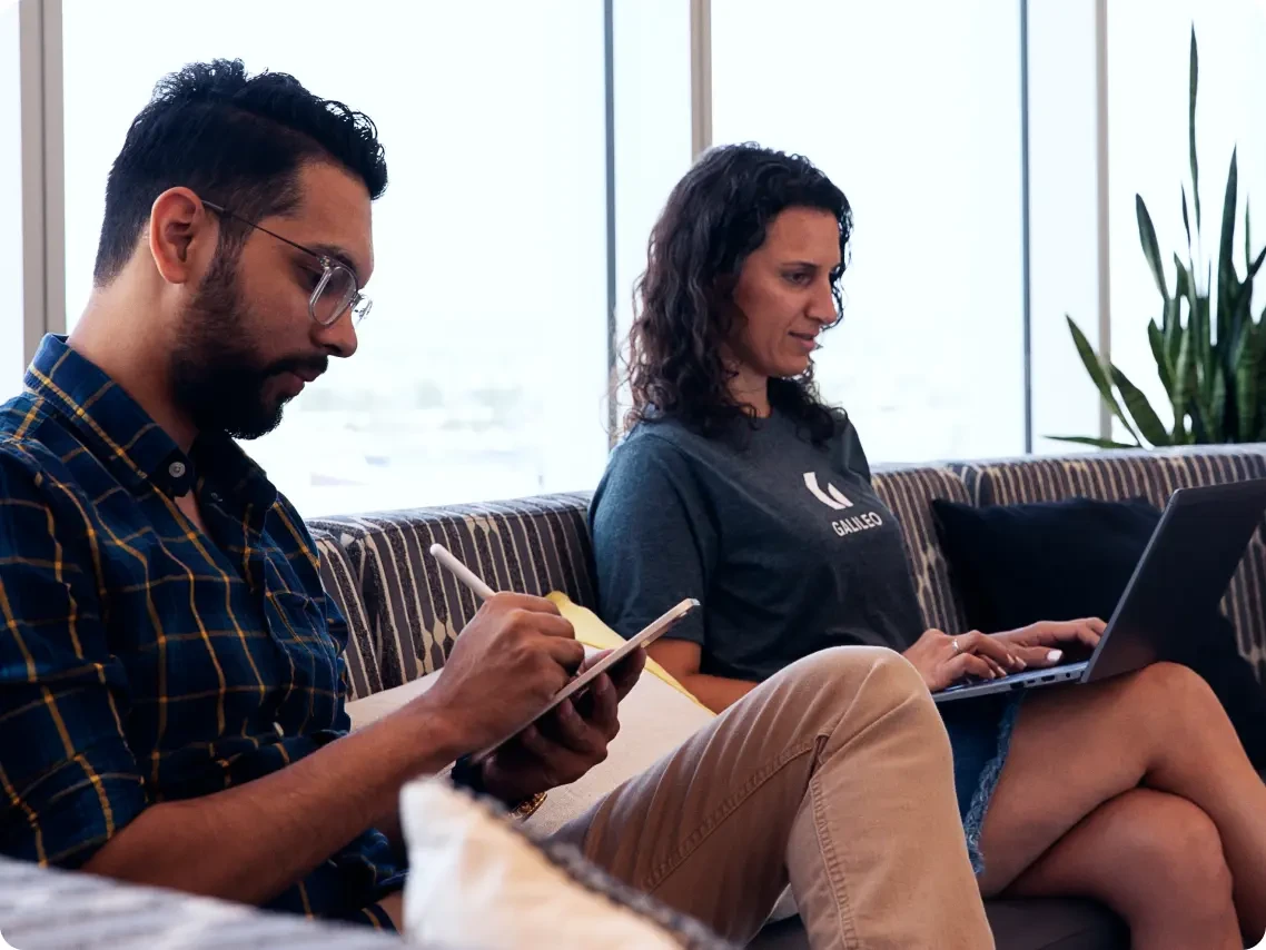 two people sitting on a couch