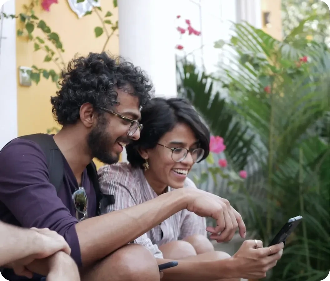 two people agreeably looking at a phone.