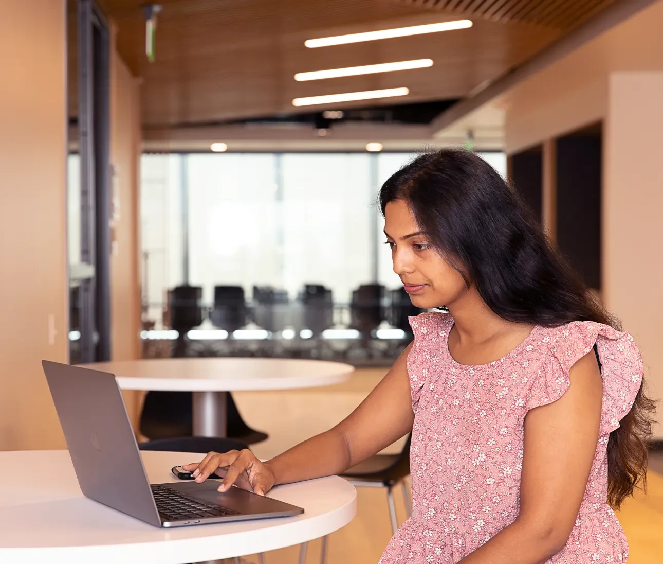 a woman checking her laptop at a table