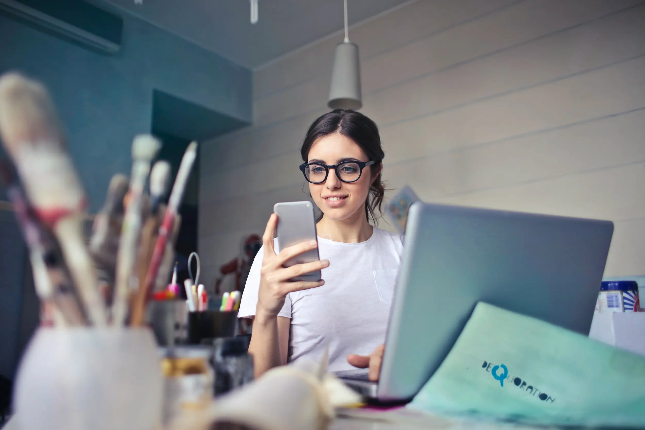 A woman looking at a phone with a smile